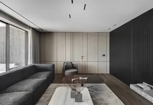Modern, minimalist living room featuring wooden furniture, glass coffee table, and concrete floor.