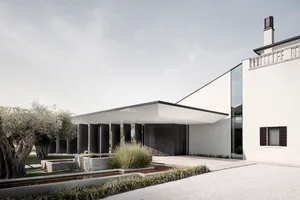 Modern exterior design featuring a minimalist architectural style with concrete and glass materials.
