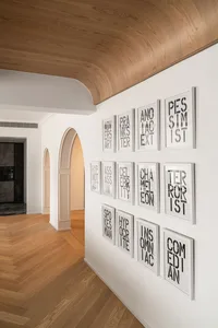 Modern interior with white framed wall text displaying various words.