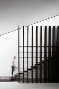 Modern interior staircase featuring glass and metal materials