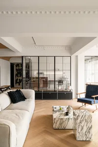 Modern living room featuring marble coffee tables and wood flooring