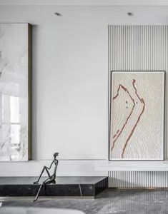 Minimalist interior design featuring marble sculptures and abstract artwork.