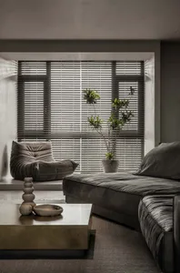 Modern minimalist living room featuring a plush velvet couch, a sleek concrete coffee table, and wooden accents on a polished