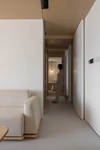 Interior of a minimalist modern apartment featuring neutral-toned materials and contemporary design elements.