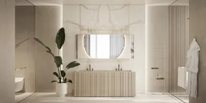 Modern bathroom featuring white marble walls, a double sink vanity, a hanging round mirror, and a potted plant