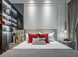 Modern bedroom featuring white and red fabric accents, with a prominent bed against a wall