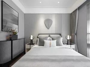 A modern bedroom featuring textured fabric bedding and walls, with minimalistic decor and a sleek, contemporary design.