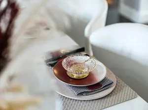 Modern coffee table with a glass bowl and wooden plates.