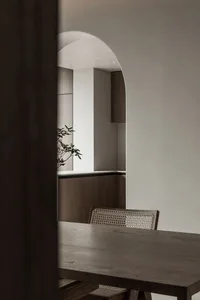 A modern dining room with wooden furniture and minimalist decor.