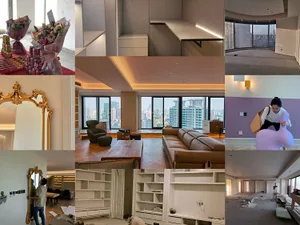 Modern living room featuring contemporary furniture and materials, with a view of the cityscape outside.