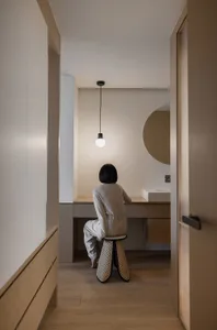 A minimalist bathroom with concrete walls and wooden elements