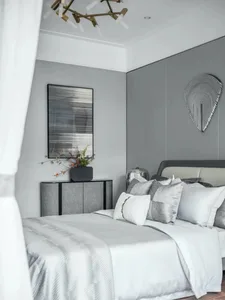 A modern minimalist bedroom with a grey bed, white bedding, and geometric art on the wall.