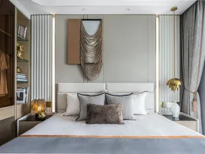 A modern minimalist bedroom featuring a bed with textured cloth, metallic pendant lights, and a gold-framed mirror.