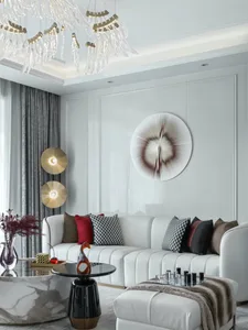 A modern minimalist living room featuring a white leather sofa, marble coffee table, and glass chandelier.