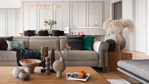 A modern sofa adorned with colorful decorative pillows and a plant, surrounded by various decorative items on a wooden coffee