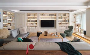 A modern living room featuring wooden furniture and carpet