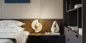Modern minimalist bedroom with metal headboard and wooden accents.