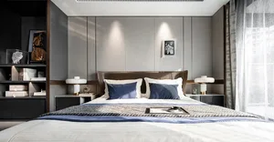 An elegant, minimalist bedroom with a white bed, grey paneling, and a mix of white and grey decorative elements.