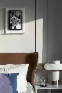 Modern bedroom featuring a sleek acrylic nightstand with a minimalist design.