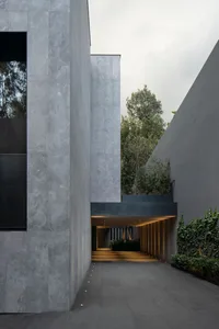Modern building with concrete exterior and greenery.