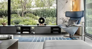 Modern living room featuring a leather chair and a metal side table.