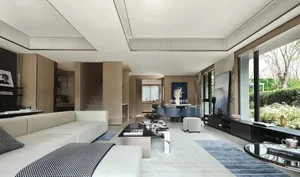 Modern living room with a white sectional sofa and black and white coffee table.