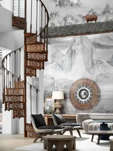 A modern living room featuring a decorative wooden spiral staircase, plush seating, and minimalist decor with a monochrome co