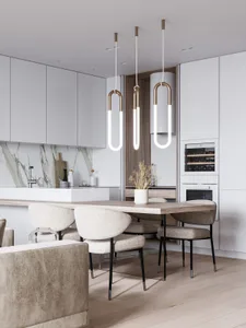 A modern minimalist kitchen with a marble backsplash, wooden table, and metal pendant lights.