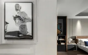 Modern bedroom with minimalist design featuring neutral-toned furniture and a cozy atmosphere.