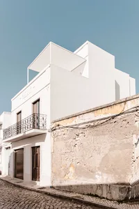 A modern residential building made of concrete and glass.