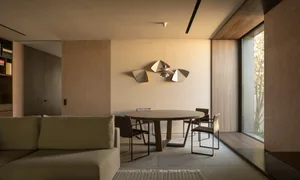 Modern residential dining room with wood and metal furniture.