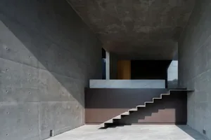 Concrete staircase in a modern interior setting with minimalist design.