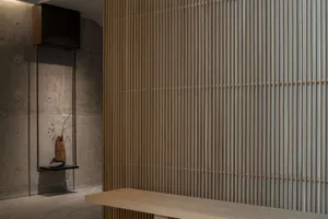 A minimalist interior design featuring wooden accents, including a wooden bench against a wooden-paneled wall.
