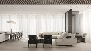 Modern living room with minimalist design featuring a white sofa, black chairs, and a light wooden floor, with large windows 