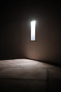 A minimalist room with elegant lighting and tiled floor.