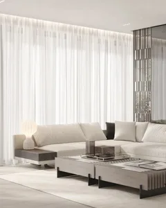 Modern minimalist living room featuring a sofa with fabric upholstery and a transparent glass coffee table.