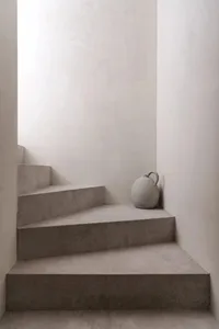 Concrete staircase adorned with a minimalist, modern vase