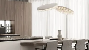 Modern kitchen featuring marble countertops and wooden cabinets and dining table