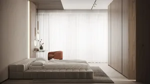 A modern, minimalist bedroom featuring a white tufted bed, light wood cabinetry, and a combination of minimalist and industri