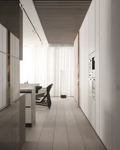 Modern residential kitchen with concrete flooring, furniture, and appliances