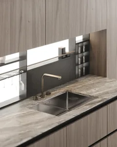 Modern residential kitchen with marble countertops and sink.