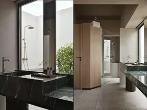 A modern bathroom featuring marble accents and concrete flooring.