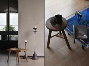 Modern living room accessories with wooden stools and candle holders.