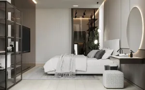 A modern minimalist bedroom with white walls, a large bed, and minimalist furniture.