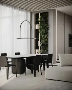 Modern residential dining room featuring a marble table, black chairs, and a hanging light fixture.