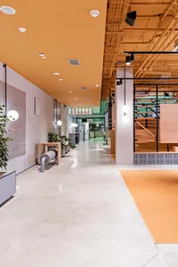 Industrial-style restaurant interior featuring concrete walls, metal accents, and wooden elements.