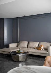 A modern living room featuring a luxurious leather sofa with marble accents and a geometric coffee table.