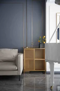 A modern living room featuring minimalist decor with metallic and glass elements.