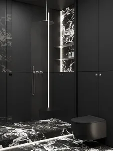 Black modern minimalist bathroom with marble tiles and fixtures.