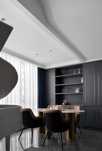 Modern dining room featuring marble table and metal chairs.